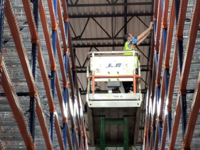 installing warehouse labels on scissor lift