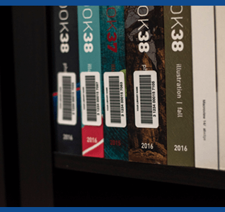 Row of library books with barcode labels for tracking