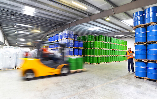 warehouse forklift truck moving chemical drums