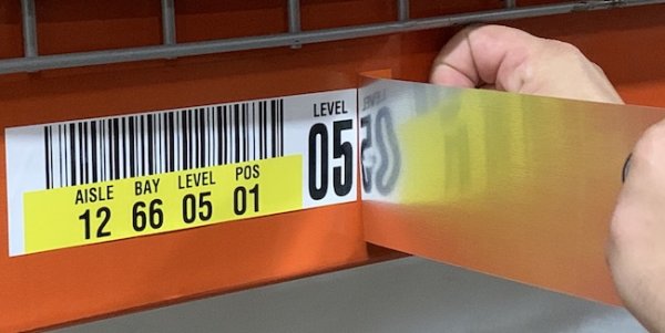 Applying warehouse rack label cover up solution