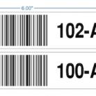 warehouse shelf label with barcodes, numerals and arrows