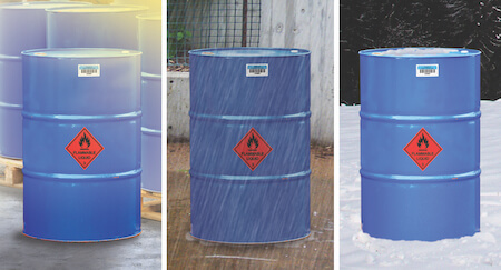 Three chemical drums in sun, rain and snow, each with asset tags